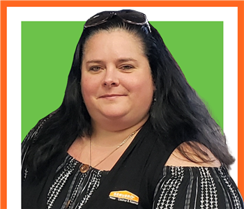 female, SERVPRO employee in front of green background