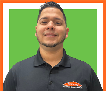 Leo, SERVPRO employee against green background, friendly face, smile