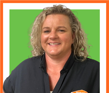 Crystal, female SERVPRO employee cut out against a green background
