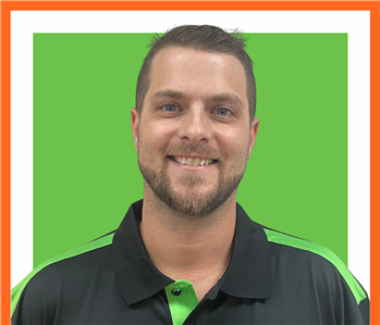 Cody, servpro employee against a green background, man
