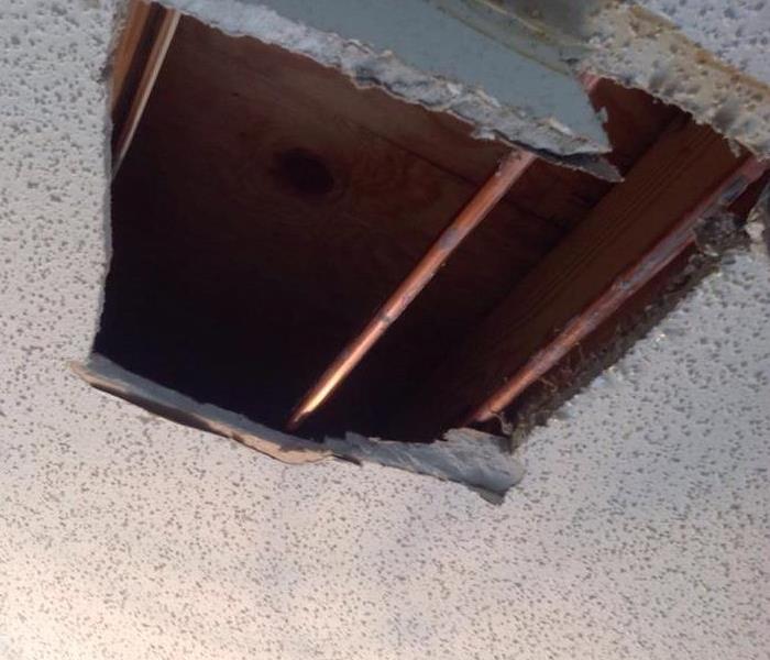 Ceiling with water damage that fell onto customer's floor