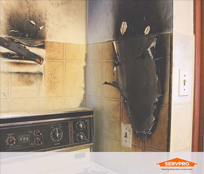 kitchen filled with soot, old yellow walls covered in soot damage